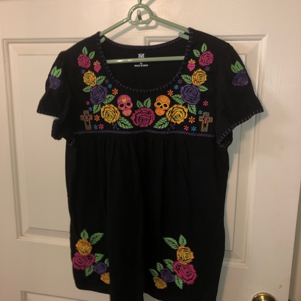 Black shirt with colorful embroidered detail